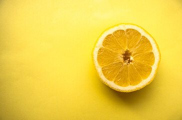 Slice of lemon on a yellow background