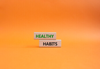 Healthy habits symbol. Concept word Healthy habits on wooden blocks. Beautiful orange background. Business and Healthy habits concept. Copy space
