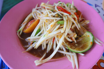 Green Spicy Papaya Salad or Som tum on plate