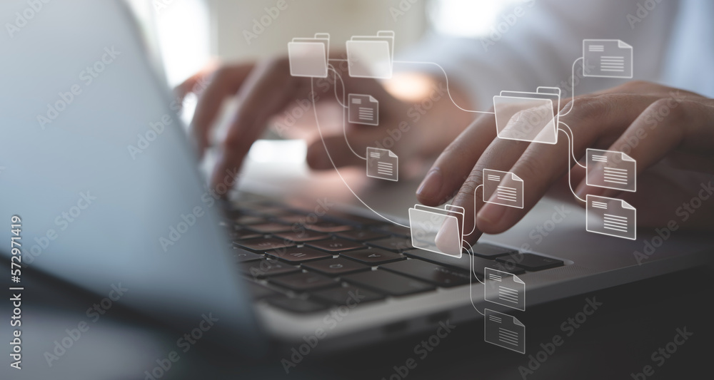 Poster document management system (dms) being setup by it consultant working on laptop computer in office w