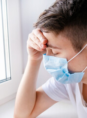 Sad Young Man in Surgical Mask