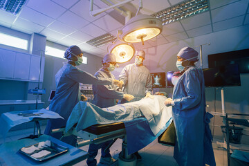 Medical Team Performing Surgical Operation in Modern Operating Room, Serious surgeons during a surgery in the hospital.