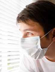 Sad Young Man in Surgical Mask