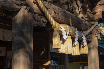 Fototapeta na wymiar A sacred rope in front of the temple at Japanese Shrine