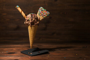 funny creative concept of flying wafer cone with ice cream covered, strewed sprinkles decorated...