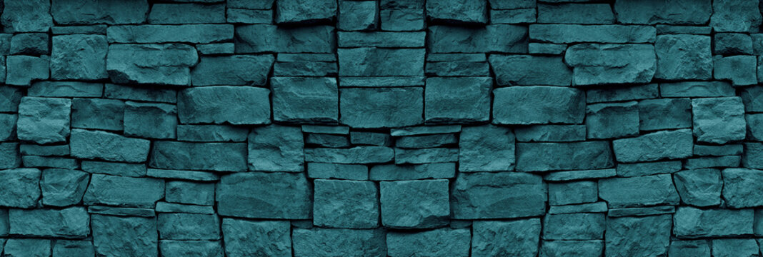 Natural stone wall teal color wide texture. Dark turquoise rough rock masonry widescreen textured background