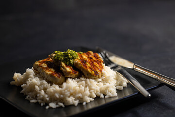 grilled poultry meat with pesto served with rice