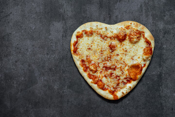 Pizza heart shaped on background . Concept of romantic love for Valentines Day . 