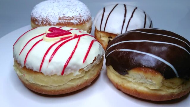Four delicious sugar, chocolate doughnuts, rotating video