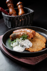 Fried Bavarian sausages with potato pancakes