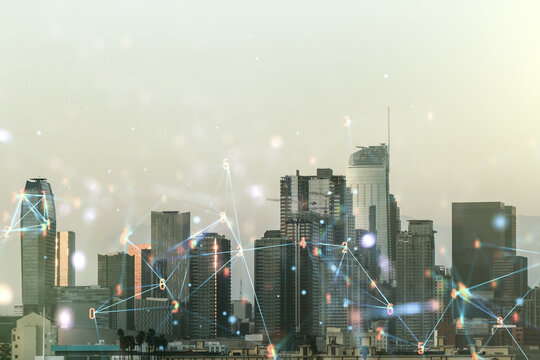 Double exposure of abstract virtual technology hologram on Los Angeles city skyscrapers background. Research and development software concept