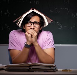Young male student sitting in classroom