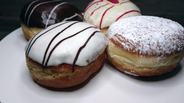 Four delicious sugar, chocolate doughnuts, rotating video