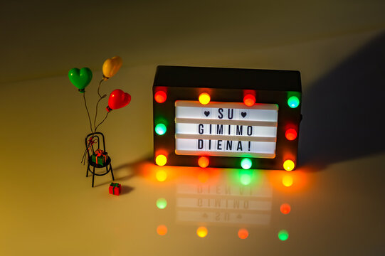 Flag of Lithuania in the shape of a hearts with Happy Birthday written in lightbox. Independence Day Concept. - Powered by Adobe