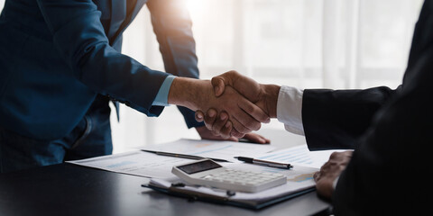 Business handshake for teamwork of business merger and acquisition,successful negotiate,hand shake,two businessman shake hand with partner to celebration partnership and business deal concept.