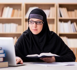 Muslim girl in hijab studying preparing for exams
