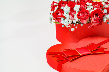 Bouquet of red roses in gift box in form of heart, free space to copy text