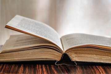 Book open old, black cover, close-up, selective focus