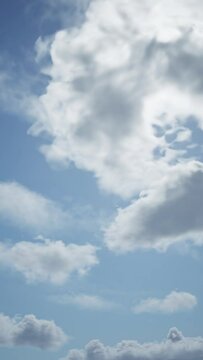 Fast moving clouds on clear blue sky with sun