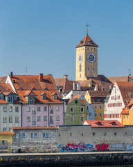 Colorful buildings and clock tower of Regensburg, Germany. - 572993258