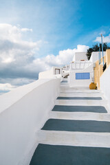 White architecture on Oia, Santorini island, Greece. White stairs in narrow street.
