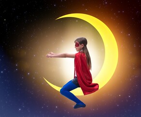 Fototapeta na wymiar Superhero kid sitting on the moon crescent