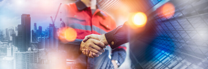 Naklejka na ściany i meble Engineer handshake for teamwork of business merger and acquisition,successful negotiate,engineer hand shake,businessman shake hand with partner to celebration partnership and business deal concept