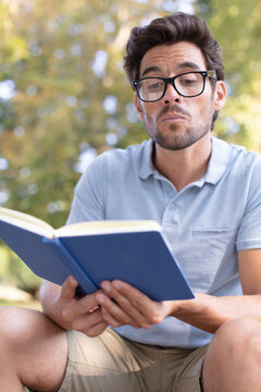 mature male boffin reading a book
