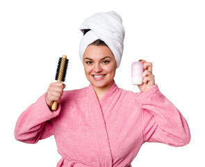 Elegant woman in a pink bathrobe, ready for the day with a hairbrush and deodorant in hand, radiating positivity and confidence