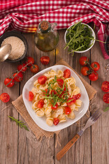 Orecchiette pasta with arugula and tomato.