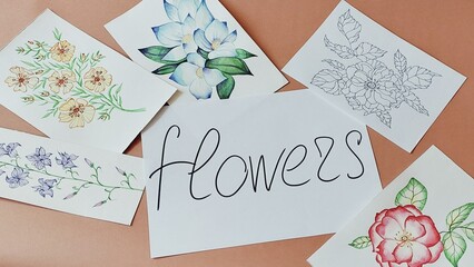 Photo of painted flowers on the table. Floral illustrations.