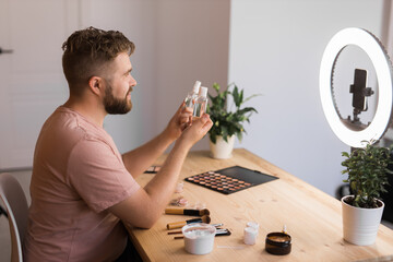 Man make up vlogger recording broadcast about cosmetics and tutorials for make-up artist