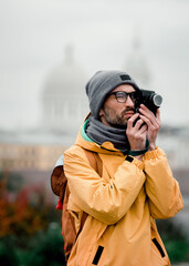 Street photographer in a yellow jacket