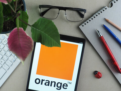 In this photo illustration, Orange S.A. logo seen displayed on a tablet.