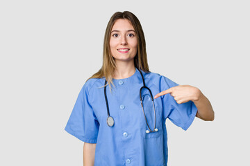 Young female nurse in uniform with stethoscope, symbol of care and dedication to patients touching back of head, thinking and making a choice.