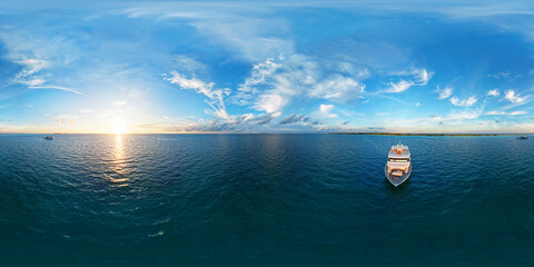 Luxury yacht next to one of the atolls of the Maldives. Aerial seamless spherical 360 degree panorama