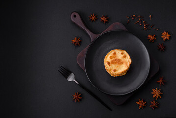 Delicious fresh pancakes with berry jam on a black ceramic plate