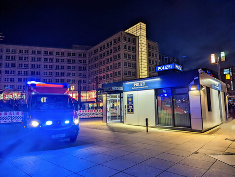 An ambulance is standing in front of the 'Alexwache' police station on Alexanderplatz in Berlin-Mitte with blue lights on