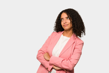 Young african american curly woman isolated dreaming of achieving goals and purposes