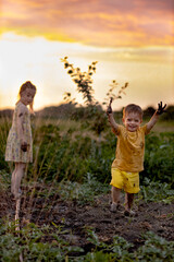 children in the field playing with splashes