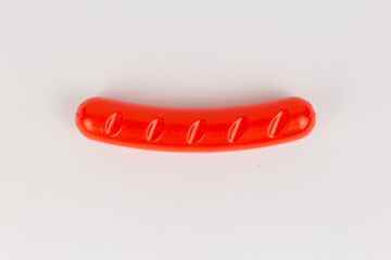 plastic sausage grill children's toy on a white background