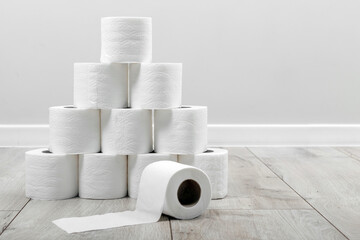 A pyramid built from white soft toilet paper in interior background