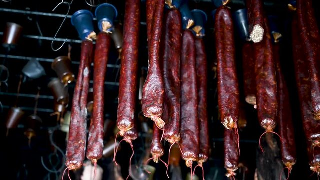 Meat drying in smokehouse. Homemade smoked meat and sujuk. Hanging beef meat.