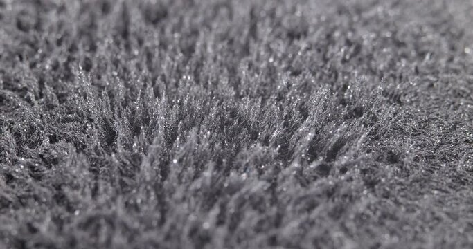Metal dust, shavings, iron powder under the influence of a magnetic field. Abstract background. The surface is a black movable background. The natural phenomenon of magnetism substances.