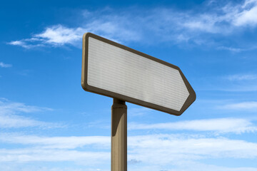 Blank right directional signpost with blue sky in the background