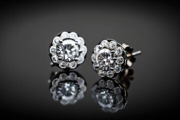 Elegant shiny Sparky platinum and diamond earrings with black background. Generative AI