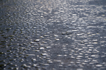 Drops of water lies on new asphalt road
