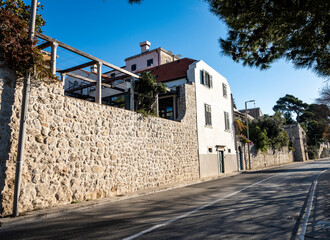 Beautiful houses in Dubrovnik with stone details and walls with wooden pergolas