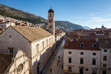 Fototapeta na wymiar Franciscan Church and Monastery rising above Stradun street in amazing, fortified city of Dubrovnik