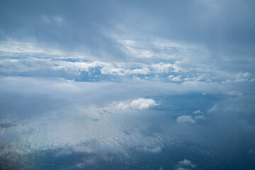 Naklejka na ściany i meble 飛行機の中から見た空と雲と海